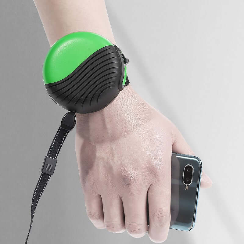 Wrist-type pet watch leash in use on a hand, showcasing a green and black design with a retractable strap.