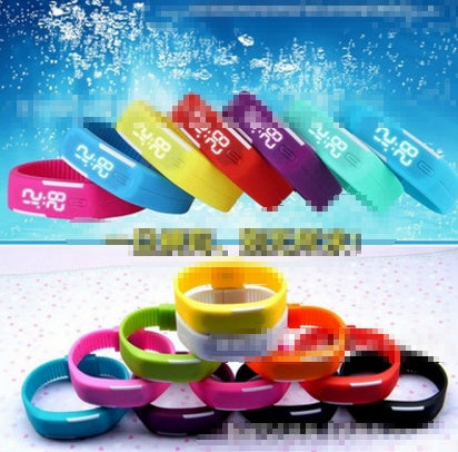 Colorful LED Wrist Watches displayed against a water background, showcasing various styles and designs.