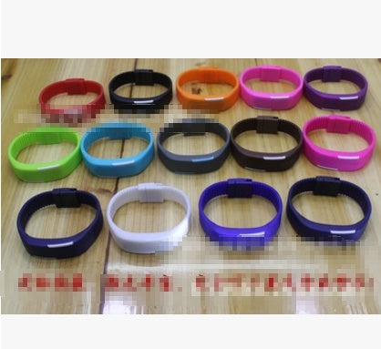 Colorful collection of LED Wrist Watches displayed on a wooden table.